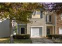 Tan two-story townhome with attached garage and landscaping at 9036 Bradstreet Commons Way, Charlotte, NC 28215