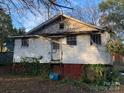 Rear view of a small white house showing some damage at 495 Carver St, Kannapolis, NC 28083