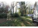 Spacious backyard with mature trees, ideal for relaxation and privacy at 1541 Hunt Club Ct, Rock Hill, SC 29732
