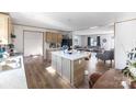 Open kitchen with island and view into living room at 210 Sailwinds Rd, Mooresville, NC 28115