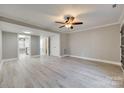 Open living space with light walls, ceiling fan and wood-look floors at 1830 Ebenezer Rd, Rock Hill, SC 29732