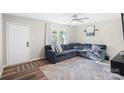 Spacious living room featuring a sectional sofa, large TV, and ceiling fan at 624 Dundeen Dr, Gastonia, NC 28052
