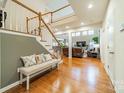 Bright entryway with hardwood floors, bench, and view of the living room at 10126 Loch Lomond Dr, Charlotte, NC 28278