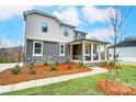 Two-story house with gray siding, stone accents, and a landscaped yard at 14421 Autumncrest Rd # 3, Huntersville, NC 28078