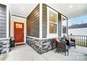 Inviting front porch with stone base and comfortable wicker chairs at 14421 Autumncrest Rd # 3, Huntersville, NC 28078