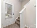 Interior entryway with staircase, wood flooring, and white door at 2304 Via Dei Conte Aly, Charlotte, NC 28205
