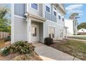 Townhome exterior featuring gray siding, walkway, and landscaping at 2304 Via Dei Conte Aly, Charlotte, NC 28205