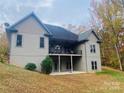 Home's back elevation, showcasing a deck and wooded area at 2818 Rockford Rd, Shelby, NC 28152