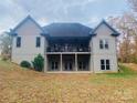 Back of house with two-story deck, overlooking a sloped yard at 2818 Rockford Rd, Shelby, NC 28152