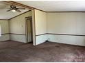 Spacious living room with carpet and wood trim at 299 Stikeleather Rd, Hiddenite, NC 28636