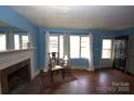 Living room with hardwood floors and a fireplace at 3217 Enfield Rd, Charlotte, NC 28205