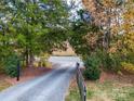 Gravel driveway with trees on either side leading to home at 7919 Concord Hwy, Monroe, NC 28110