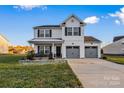 Two-story house with gray accents, double garage, and landscaped lawn at 113 Dublin Ct, Statesville, NC 28677