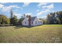 White sided home with a large backyard and driveway at 130 E Branch Ave, Shelby, NC 28152