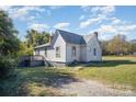 White sided home with a deck and a large backyard at 130 E Branch Ave, Shelby, NC 28152