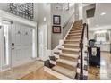 Elegant staircase with dark wood railings and carpeted steps at 2824 Huckleberry Hill Dr, Fort Mill, SC 29715