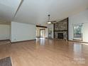 Open living area with hardwood floors, high ceilings and fireplace at 6723 Stillmeadow Dr, Charlotte, NC 28277