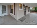 Inviting front porch with wooden flooring and view of the yard at 126 E Division Ave, Salisbury, NC 28144