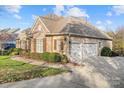 Brick home with stone accents, and a three-car garage at 14700 Old Vermillion Dr, Huntersville, NC 28078