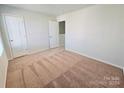 Well-lit bedroom with carpeted floor and two doors at 127 Lightning Dr, Shelby, NC 28152