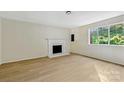 Living room with fireplace and light hardwood floors at 1514 Waybridge Ln, Charlotte, NC 28210