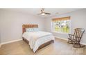 Cozy bedroom featuring a wood bed frame and rocking chair at 2027 Arboretum Rd, Rock Hill, SC 29732