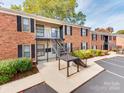Brick building exterior with stairs and landscaping at 5903 Quail Hollow Rd # D, Charlotte, NC 28210