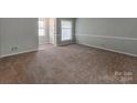 Bright living room featuring carpeted floors and a window at 5903 Quail Hollow Rd # D, Charlotte, NC 28210