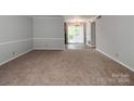 Spacious living room with carpeted floors and neutral walls at 5903 Quail Hollow Rd # D, Charlotte, NC 28210
