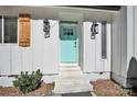 Charming front door with light teal color, wood shutters, and lanterns at 11116 Vista Canyon Dr, Charlotte, NC 28226