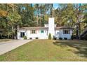 Newly renovated white house with a spacious yard and driveway at 11116 Vista Canyon Dr, Charlotte, NC 28226