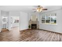 Bright living room featuring a stone fireplace and hardwood floors at 1124 Woodwinds Dr, Waxhaw, NC 28173