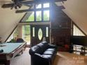 Spacious living room with a fireplace and pool table at 2484 Shelton Ave, Statesville, NC 28677