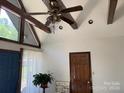 High-ceiling living room with exposed beams and large window at 2484 Shelton Ave, Statesville, NC 28677