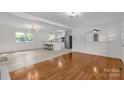 Open concept living space with hardwood floors, a fireplace, and a view of the kitchen at 4236 Dawnwood Dr, Gastonia, NC 28056