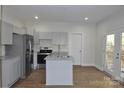 Updated kitchen with gray cabinets, granite countertops, and island at 536 Fourth St # 9, Chester, SC 29706
