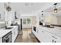 Spacious kitchen with white cabinets, quartz countertops and stainless steel appliances at 6920 Stillmeadow Dr, Charlotte, NC 28277