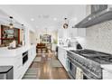 Modern kitchen featuring stainless steel appliances and white cabinets at 6920 Stillmeadow Dr, Charlotte, NC 28277