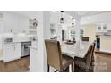 Eat-in kitchen with large island and modern pendant lighting at 6920 Stillmeadow Dr, Charlotte, NC 28277