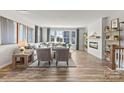 Spacious living room featuring fireplace, hardwood floors, and large windows at 7112 Brookview Ln, Sherrills Ford, NC 28673