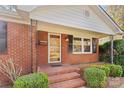 Brick front porch with a glass entry door and sidelights at 1532 Starbrook Dr, Charlotte, NC 28210