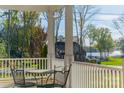 Porch with scenic lake views and charming sitting area at 21210 Bethel Church Rd, Cornelius, NC 28031