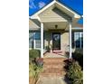 Brick steps leading to the front door, featuring a covered porch with columns at 328 Holstein Dr, Dallas, NC 28034