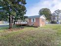 Brick ranch home with a deck and side yard at 4006 Little Mountain Rd, Gastonia, NC 28056