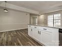 Modern kitchen island with granite countertops and white cabinets at 5003 Aberdun Ct, Charlotte, NC 28215