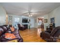 Spacious living room featuring hardwood floors, a fireplace, and ample natural light at 1335 Huckleberry Dr, Lincolnton, NC 28092