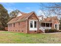 Side view of brick home showcasing a bay window and attached garage at 1560 Polk Ford Rd # 23, Stanfield, NC 28163