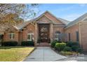 Brick home with stone accents, a double door entry and manicured landscaping at 3421 Farm View Ln, Iron Station, NC 28080