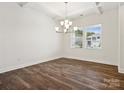 Bright dining room with hardwood floors and a modern chandelier at 1050 Bull Dog Ln, Wingate, NC 28174