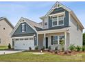 Two-story house with gray siding, white trim, and a two-car garage at 1050 Bull Dog Ln, Wingate, NC 28174